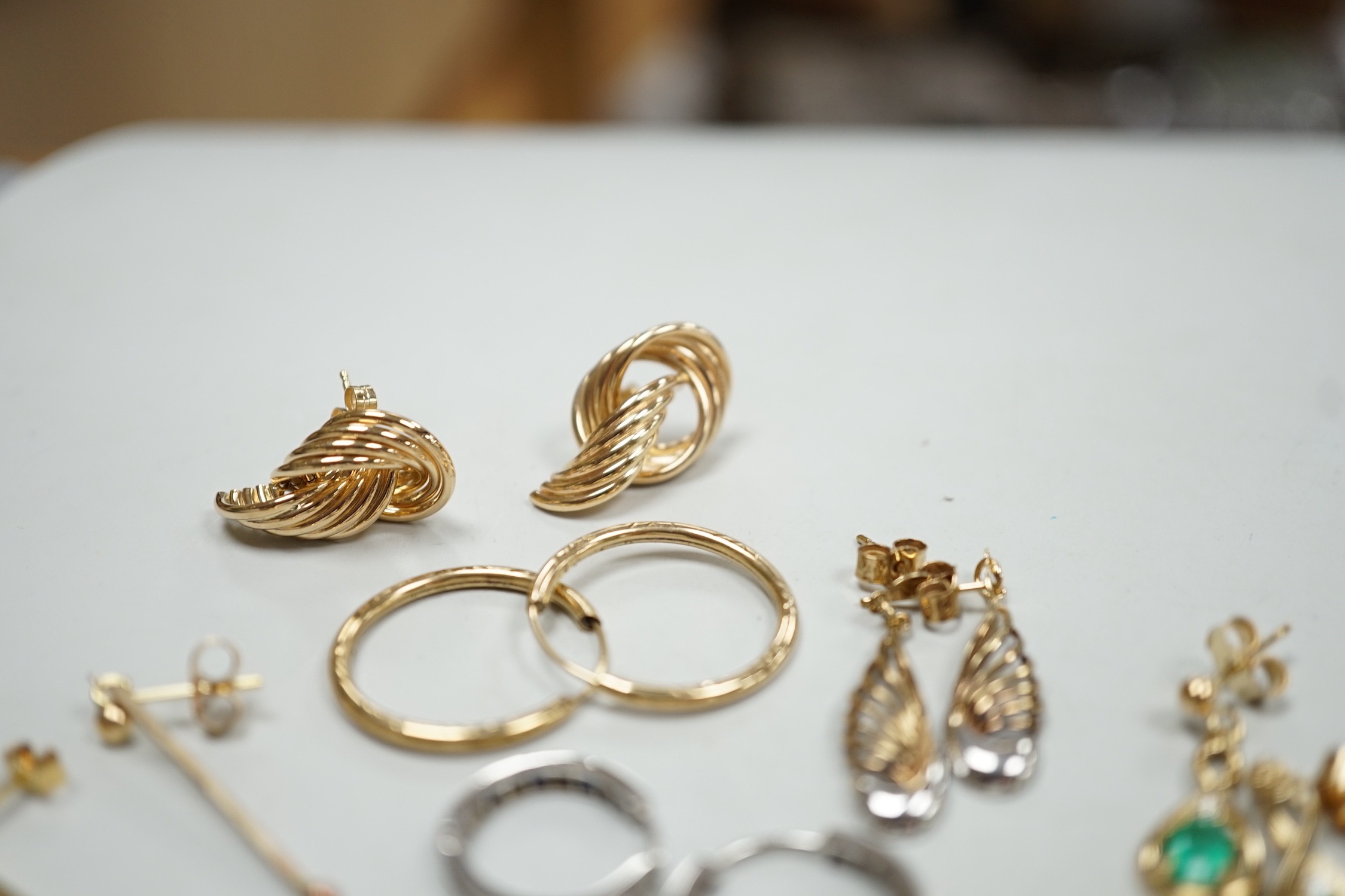 Two modern pairs of 375 earrings, a pair of 9ct, emerald and diamond set drop earrings and a pair of 9ct white gold, sapphire and diamond chip set loop earrings, gross weight 9.2 grams and two pairs of yellow metal earri